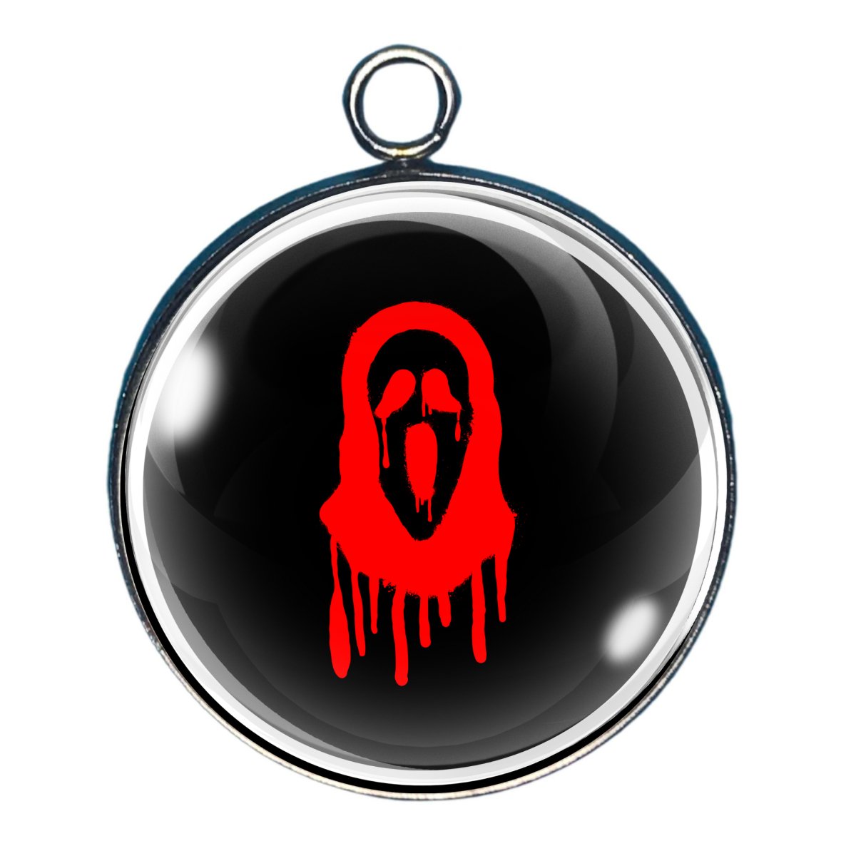 Charm of a spooky face outlined in red on a black background