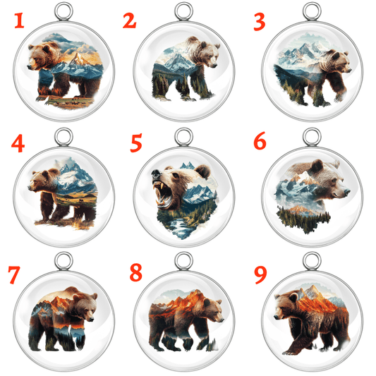Nine circular bear pendants with mountain and nature-themed designs on a white background.