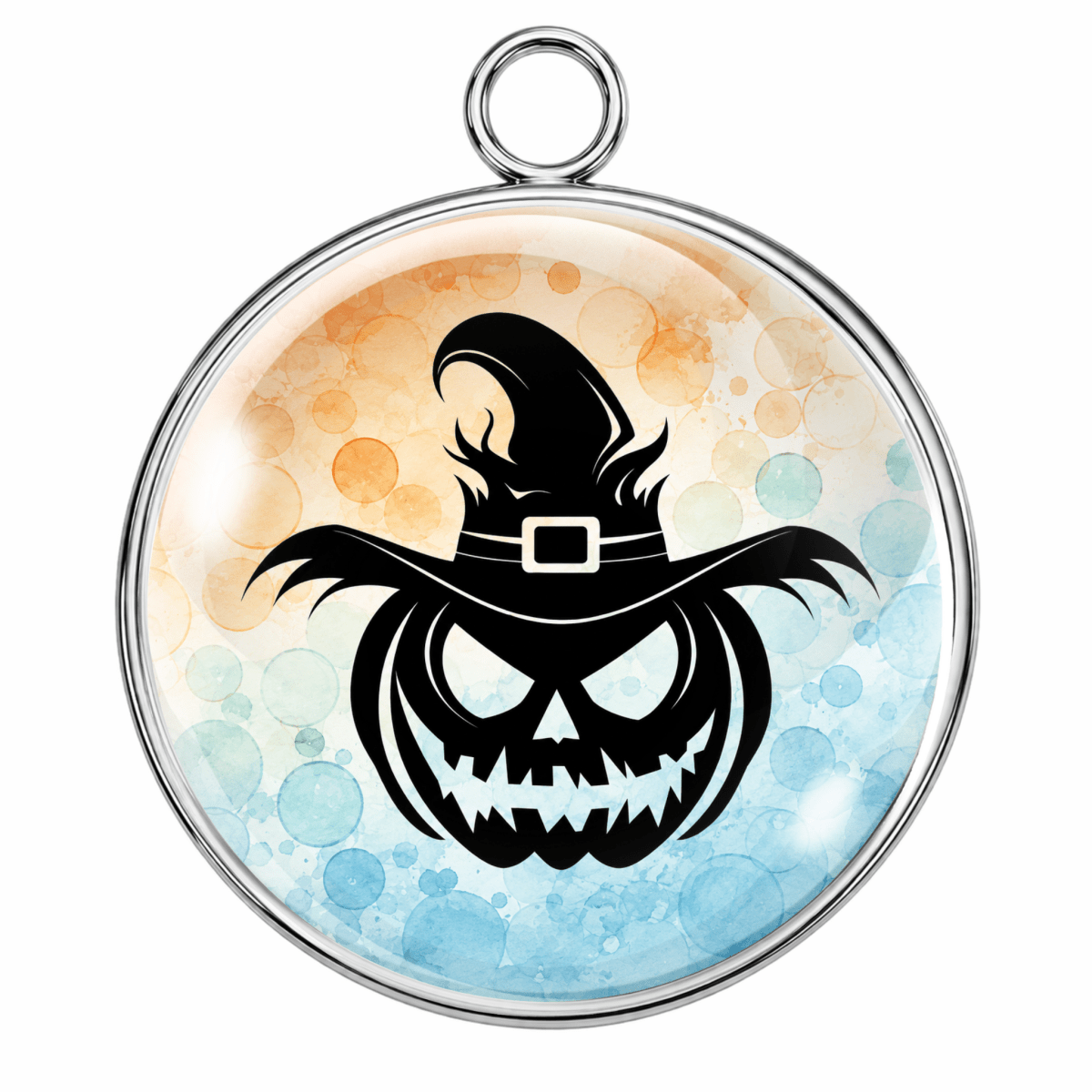 A round pendant or charm with a silver-toned metal rim and hanging loop, featuring a black witch-hat jack-o'-lantern design over a watercolor-style background with orange and blue tones.
