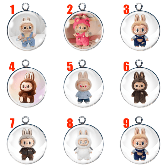 A collection of 9 handmade Labubu character charms, each in a unique costume, under clear glass cabochons with silver or gold settings.