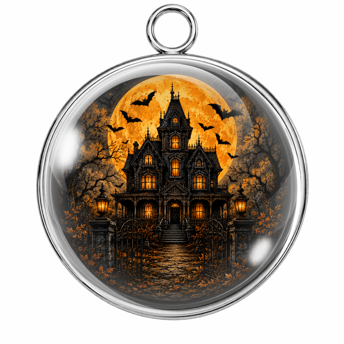 A round glass cabochon pendant with a silver metal rim and hanging loop, featuring a printed Halloween scene of a haunted gothic house under a large orange full moon with bats.