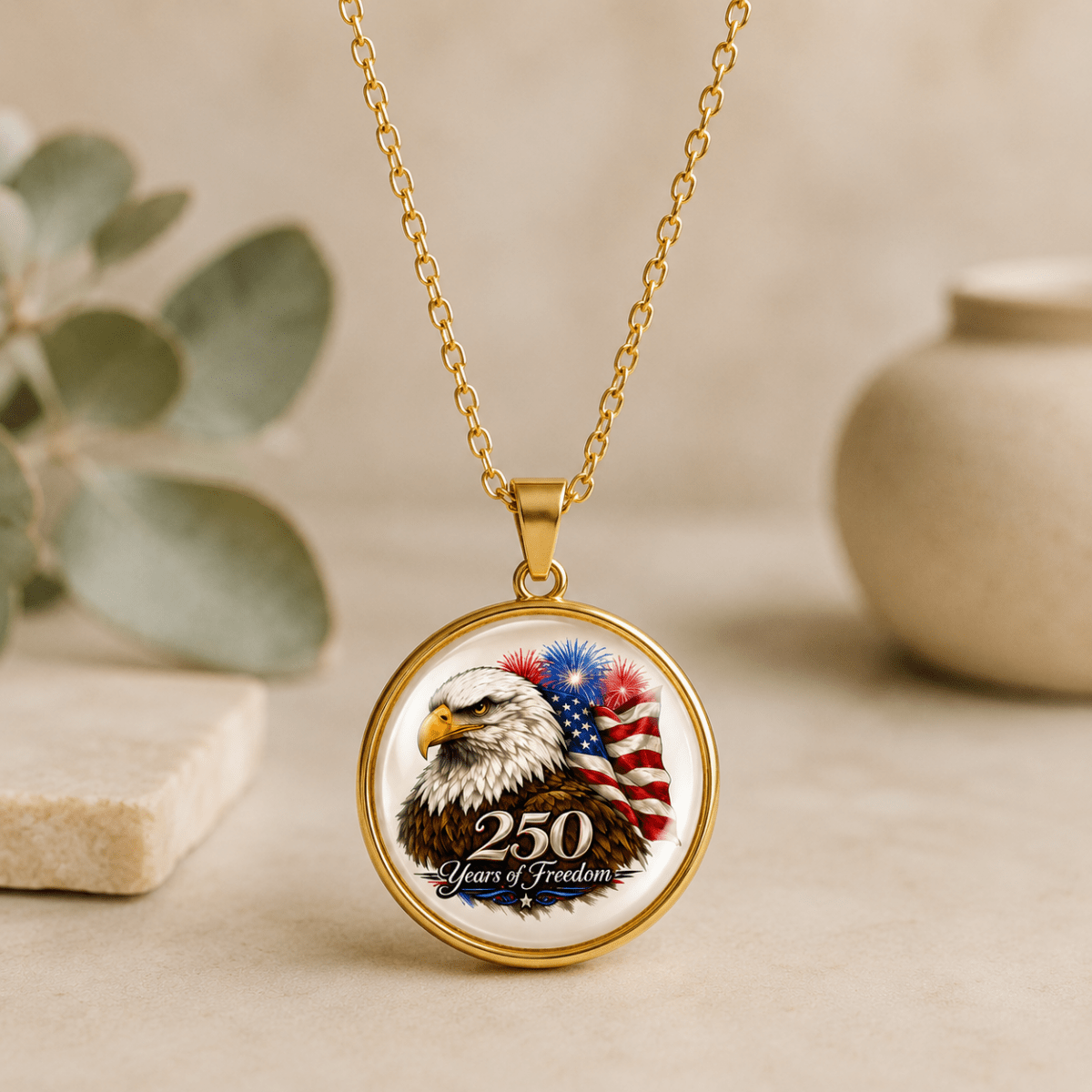 Gold necklace with a pendant featuring an eagle and American flag design on a neutral background.