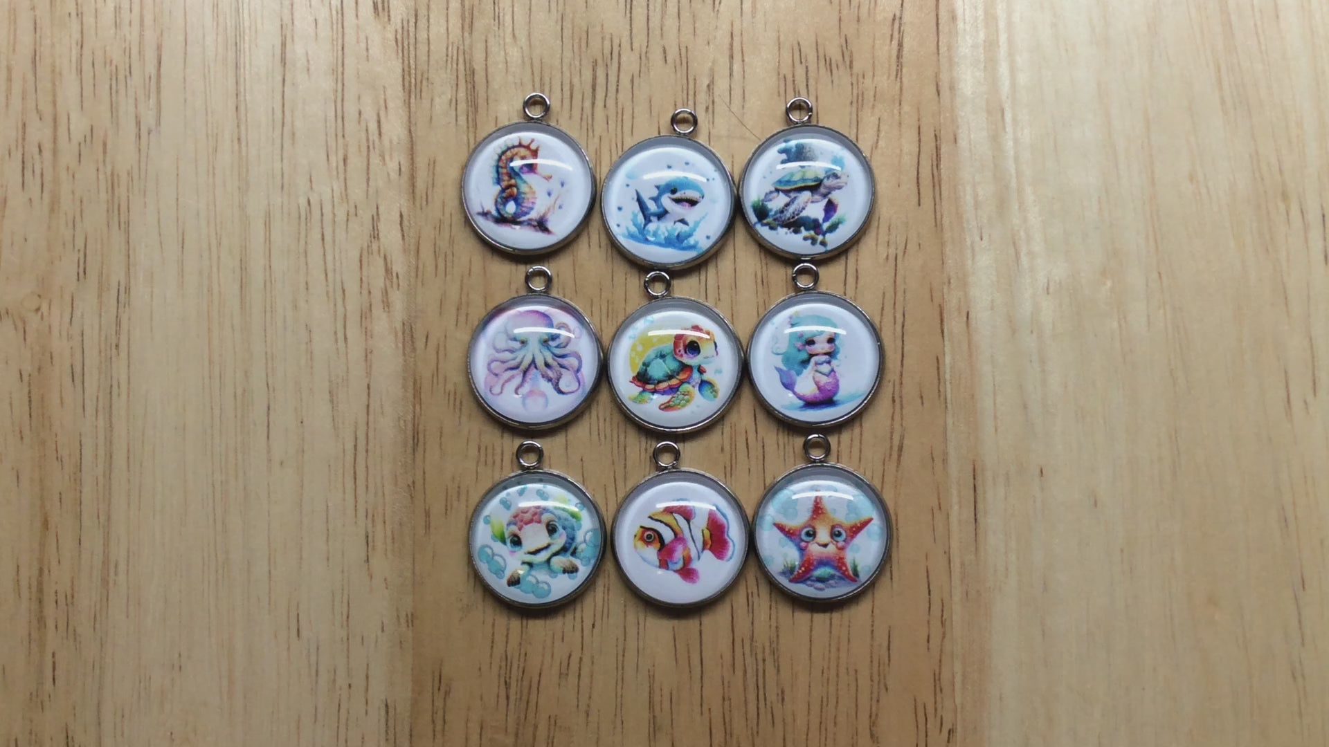 video of glass cabochon charms with a picture of saline creatures