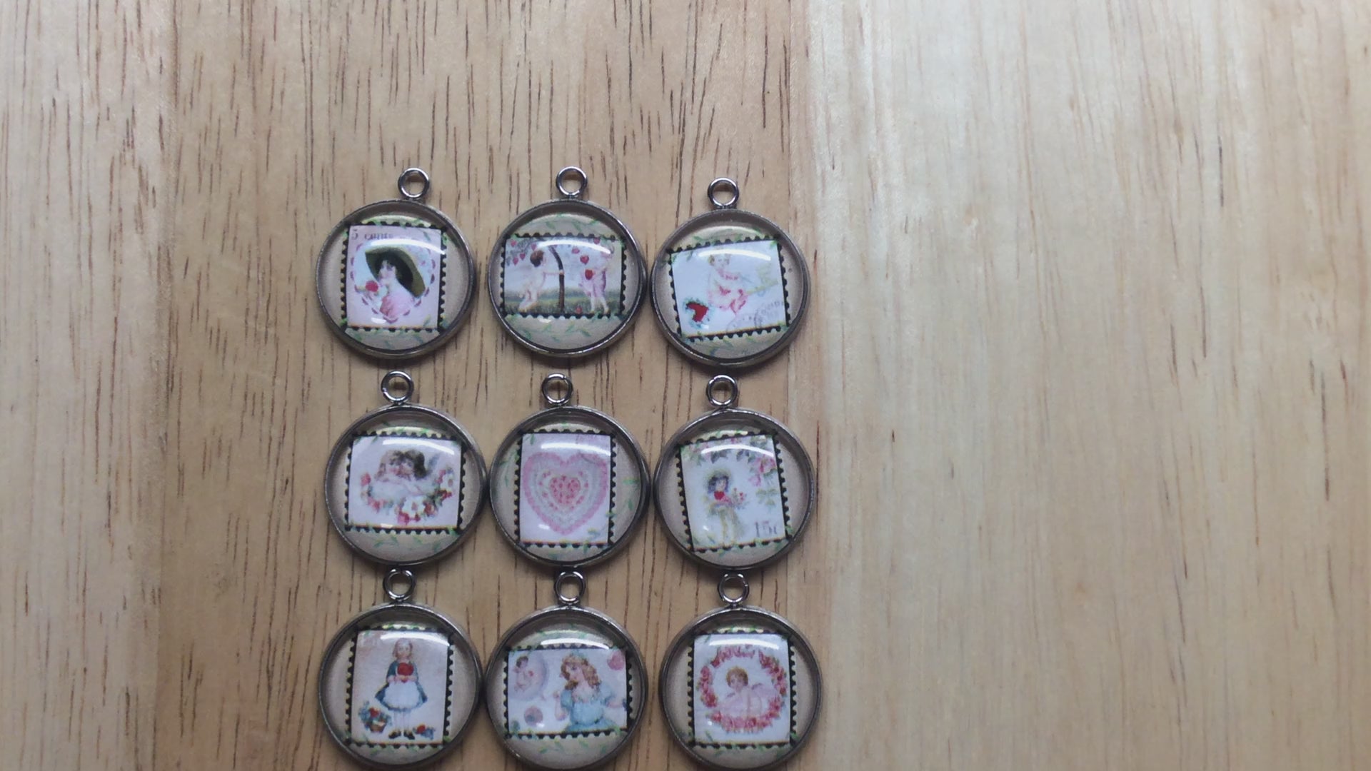 Video of 9 glass cabochon charm with picture of a vintage valentine stamp