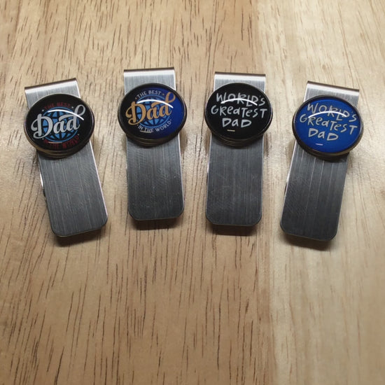 video of 4 stainless steel money clips with glass cabochons that have fathers day sayings