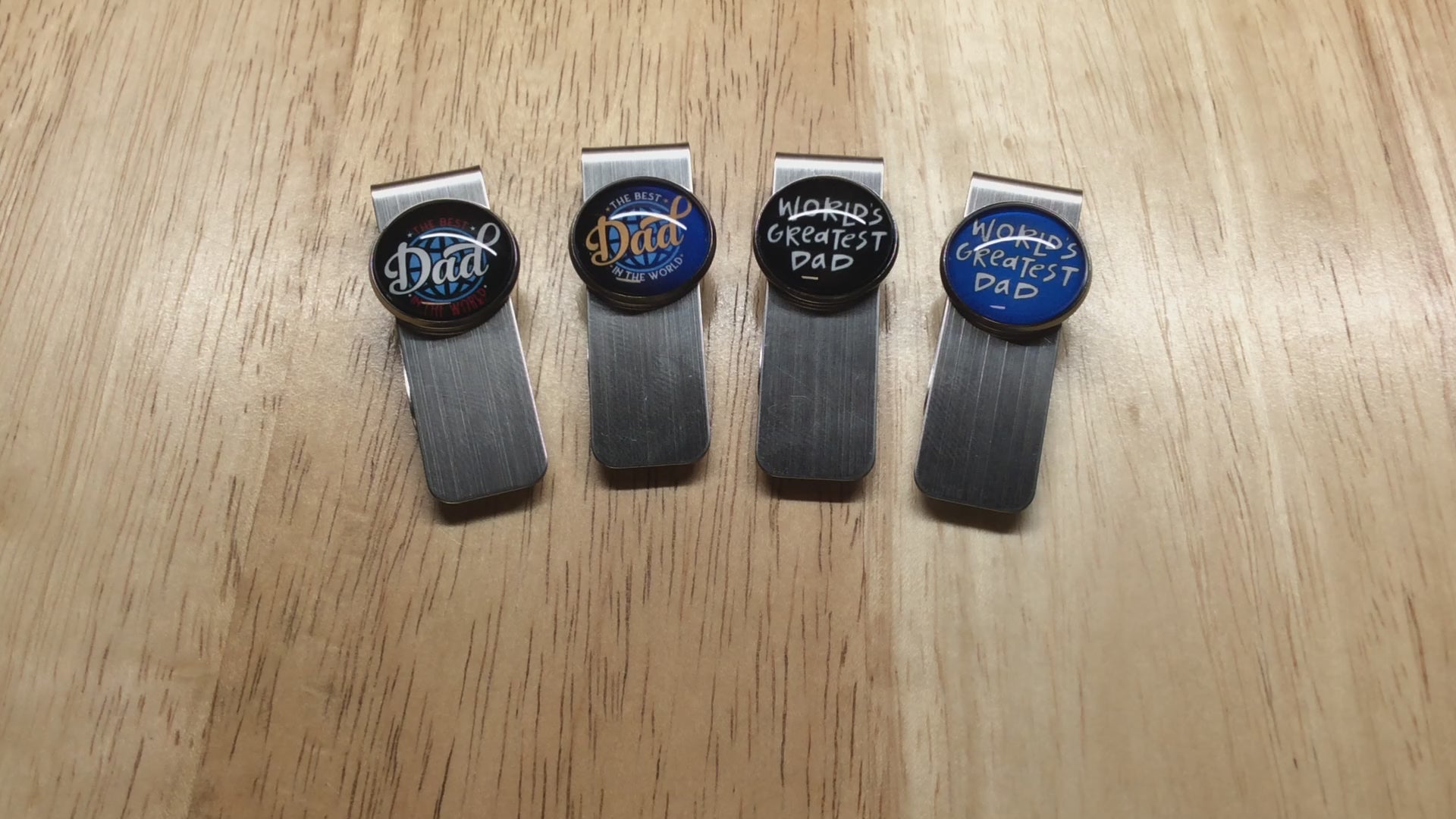 video of 4 stainless steel money clips with glass cabochons that have fathers day sayings