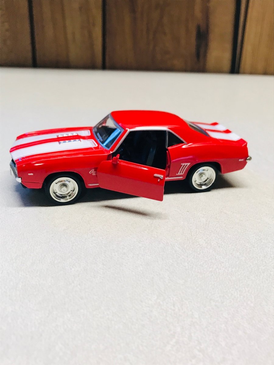 A red die-cast model car with white racing stripes on the hood and side, shown with its driver-side door open on a light gray surface.