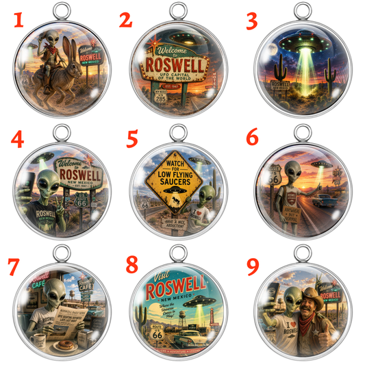 A 3x3 grid showing nine oval pendant charms with silver-toned metal borders and hanging loops, each featuring different retro-futuristic Roswell-themed illustrations including aliens, signs, cars, and desert scenes. Red numbered labels 1 through 9 appear beside each pendant on a plain white background.