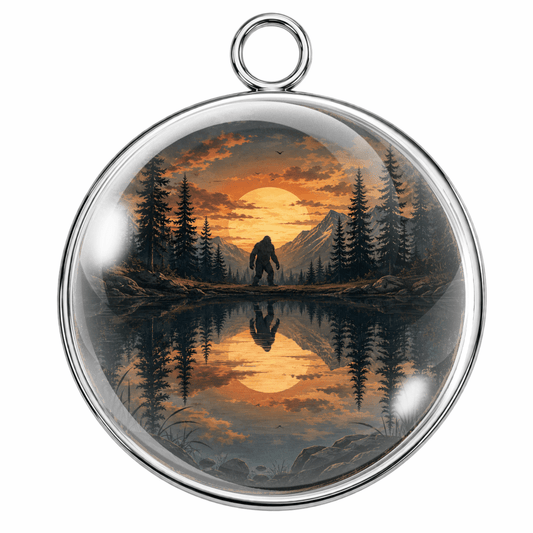 Round pendant with a Bigfoot silhouette in a forest at sunset