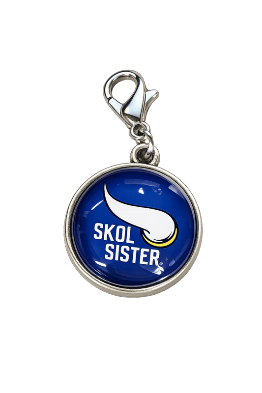 Blue pendant with 'SKOL SISTER' text and logo on a white background