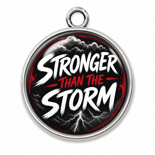 silver glass cabochon charm that says Stronger Than The Storm.
