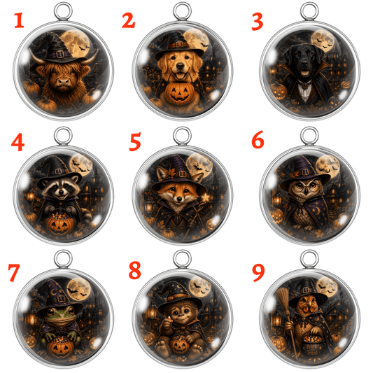 Nine Halloween-themed oval pendant designs arranged in a 3x3 grid on a white background, each with a red number in the upper left corner. The pendants feature cute animals wearing witch hats with pumpkins, candles, and full moons inside clear domed cases with silver metal borders.
