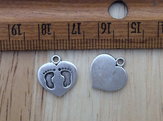 2 heart charms with footprint engravings