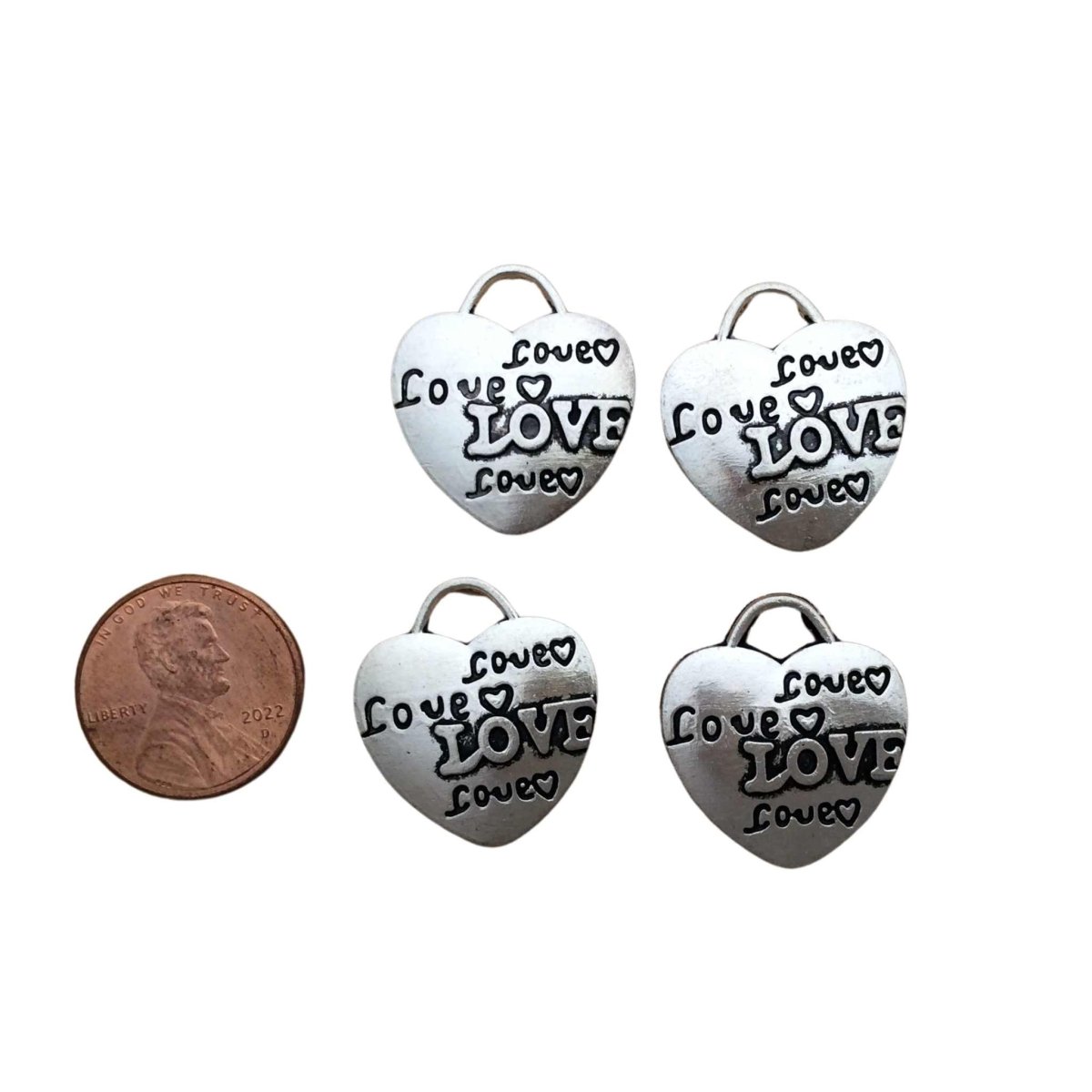 4 tibetan silver heart charms with the word"Love" 4 times with hearts on each charm 