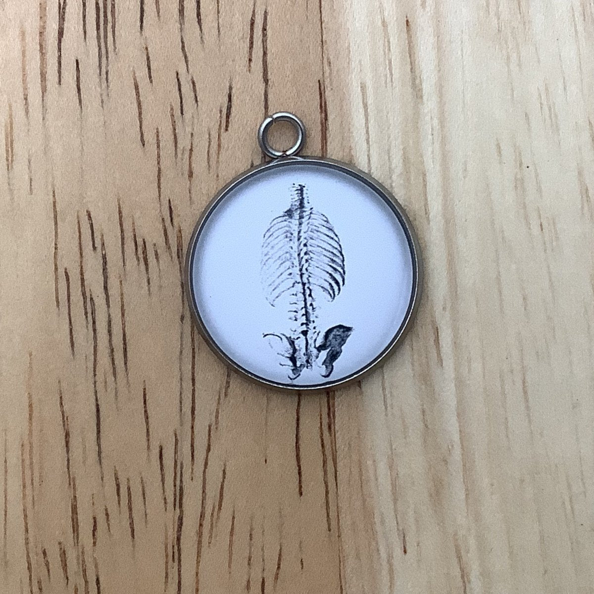 a charm featuring a drawing of the human chest and hips