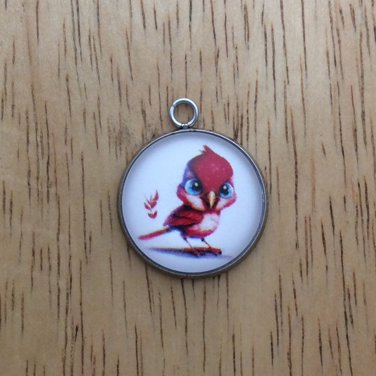 glass cabochon charm with a beautiful red bird