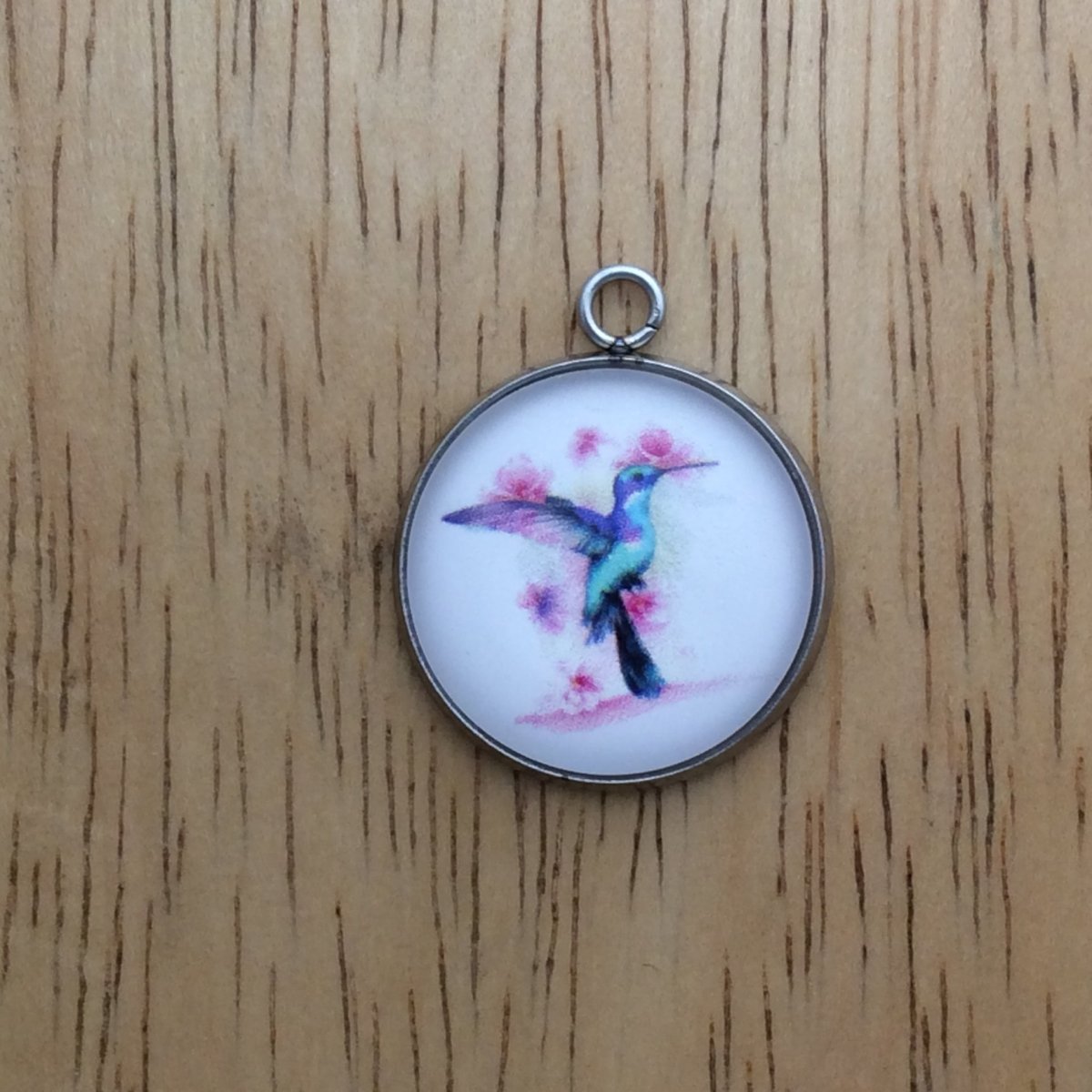 glass cabochon charm with a beautiful multicolored hummingbird