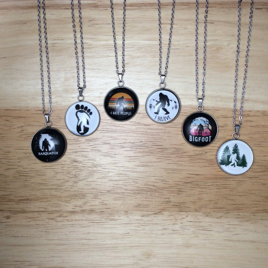 six stainless steel glass cabochon  necklaces with various scenes of bigfoot