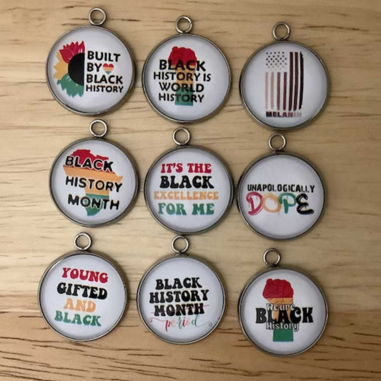 group of 9 charms showing black pride charms