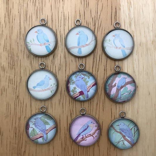 group of nine charms featuring bluebirds