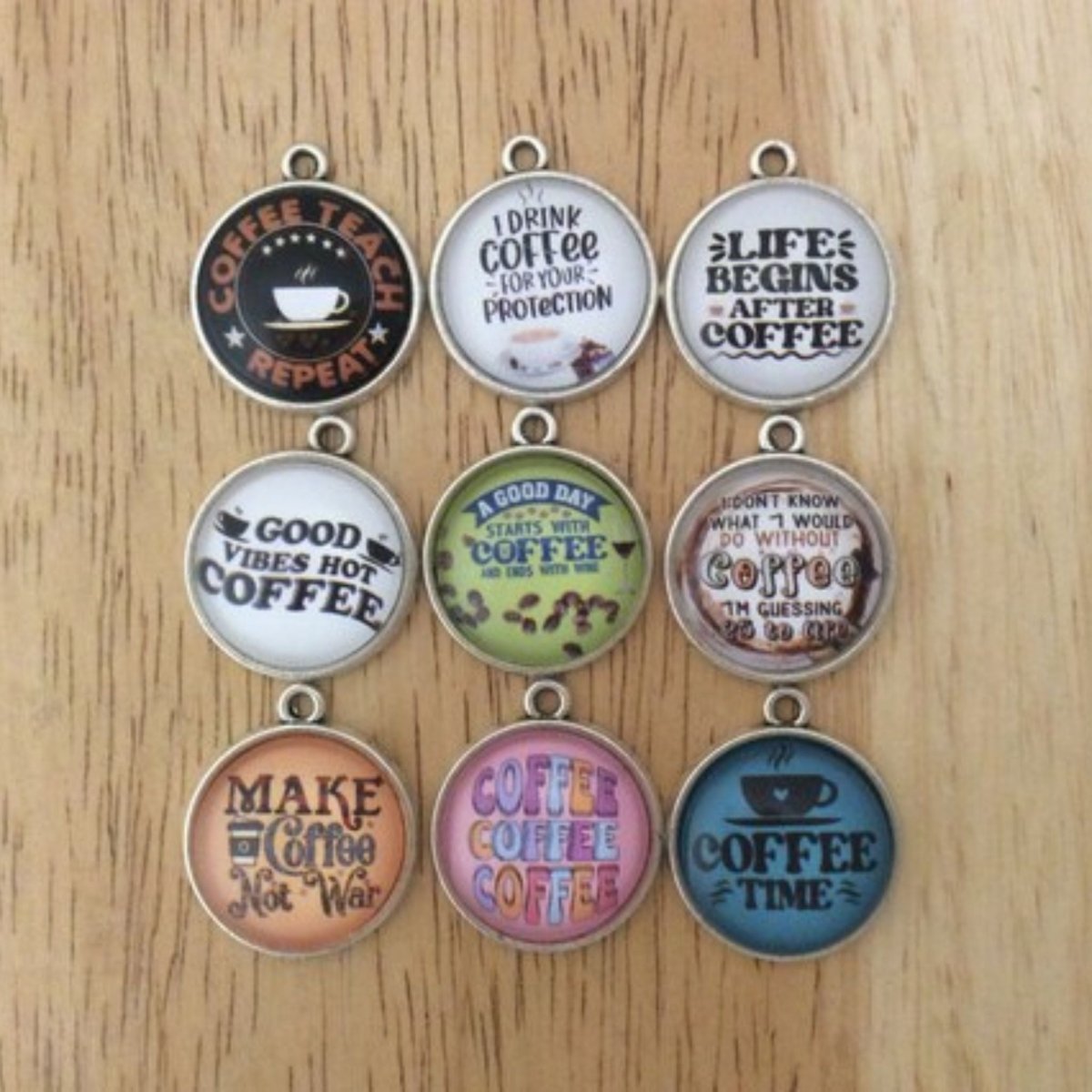 Set of 9 glass cabochon charms with various coffee sayings.