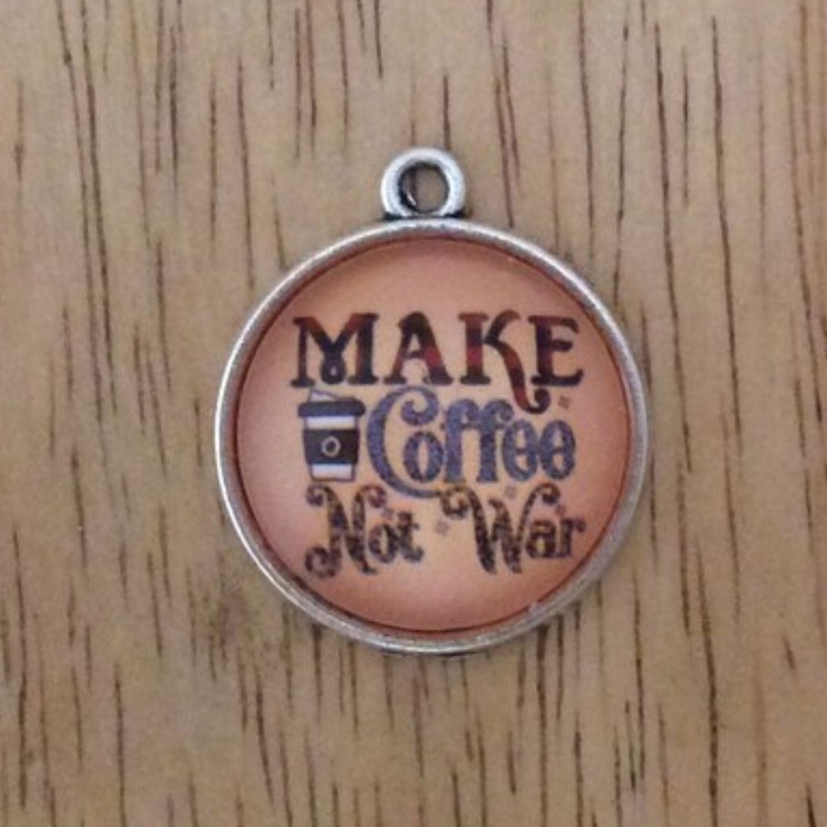 glass cabochon charm that says Make coffee not war with a picture of a to go coffee cup