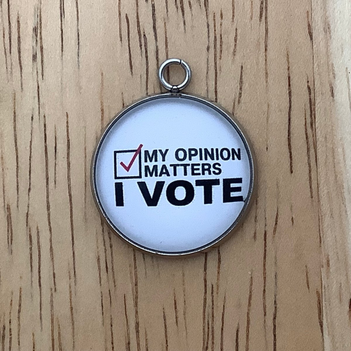 charm with 'my opinion matters, I vote' on it