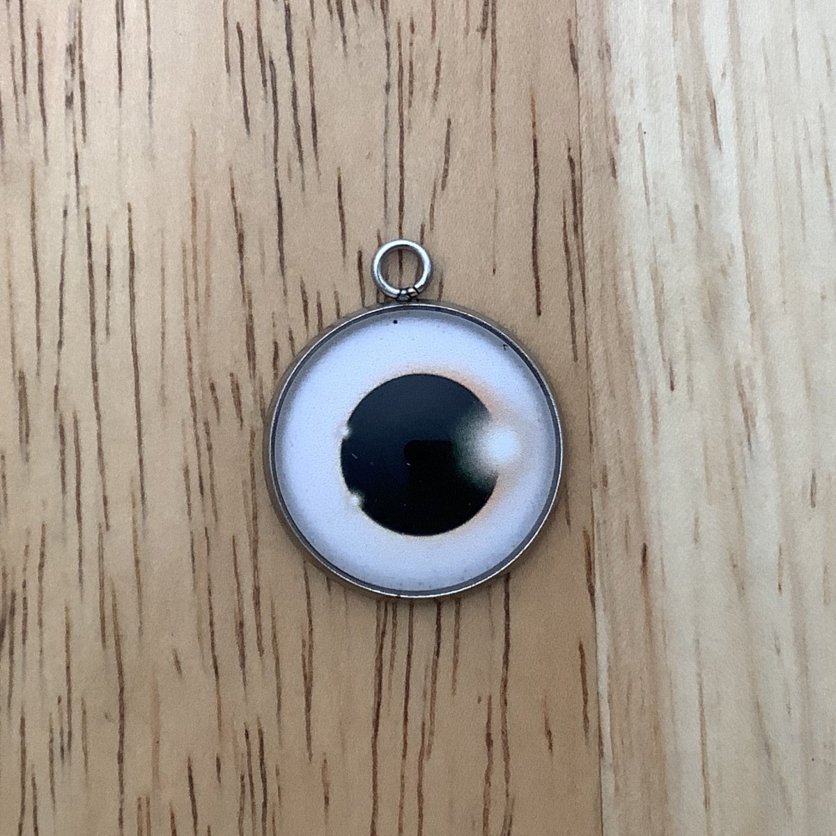 a charm depicting an eclipse