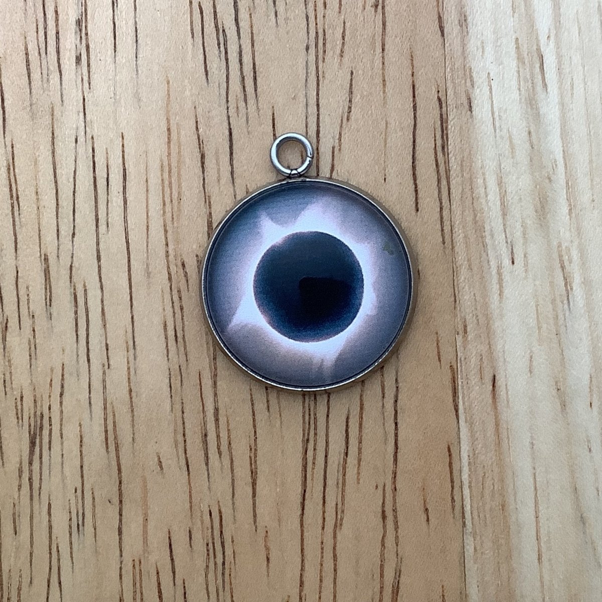 a charm depicting an eclipse