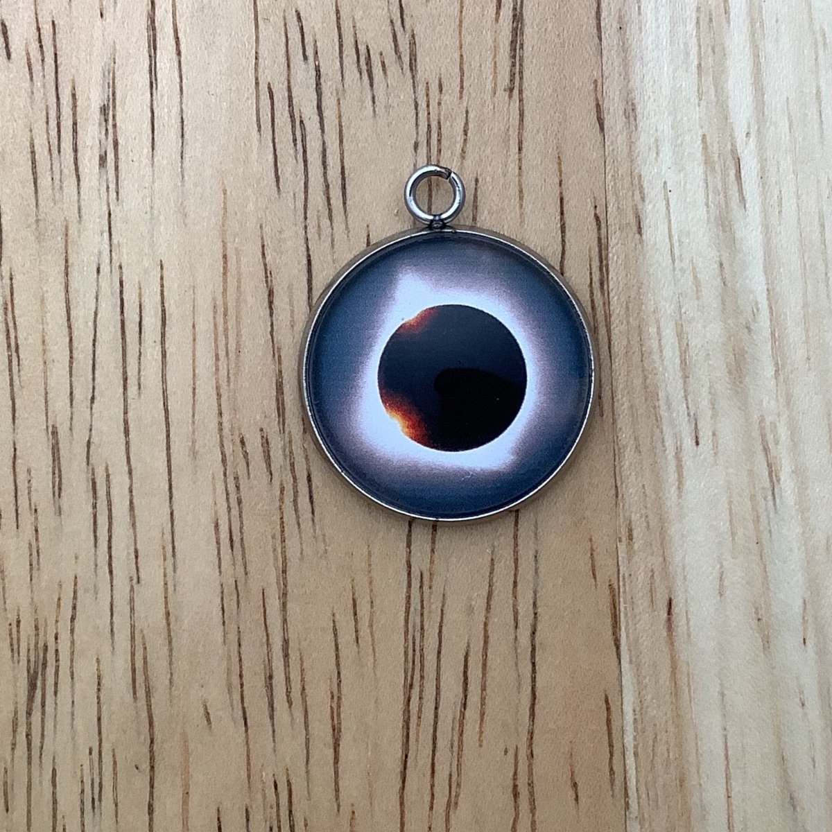 a charm depicting an eclipse