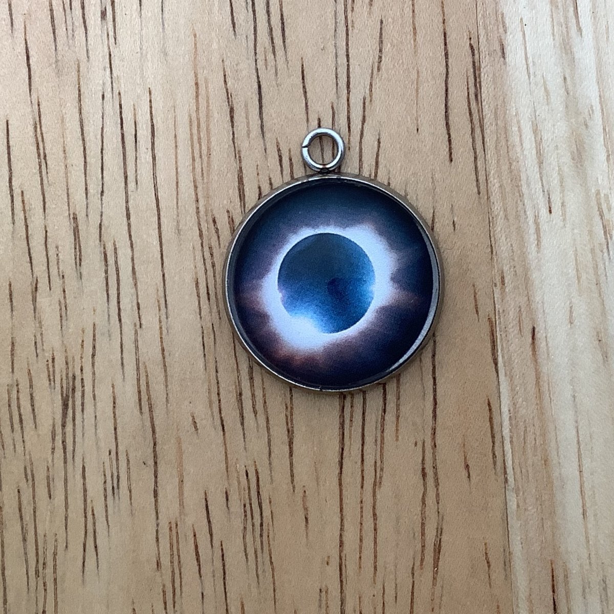 a charm depicting an eclipse