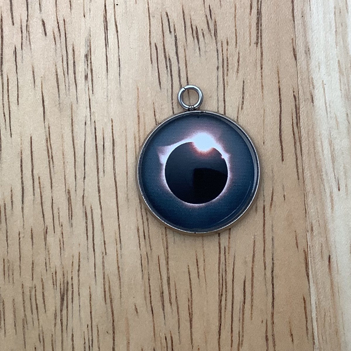 a charm depicting an eclipse