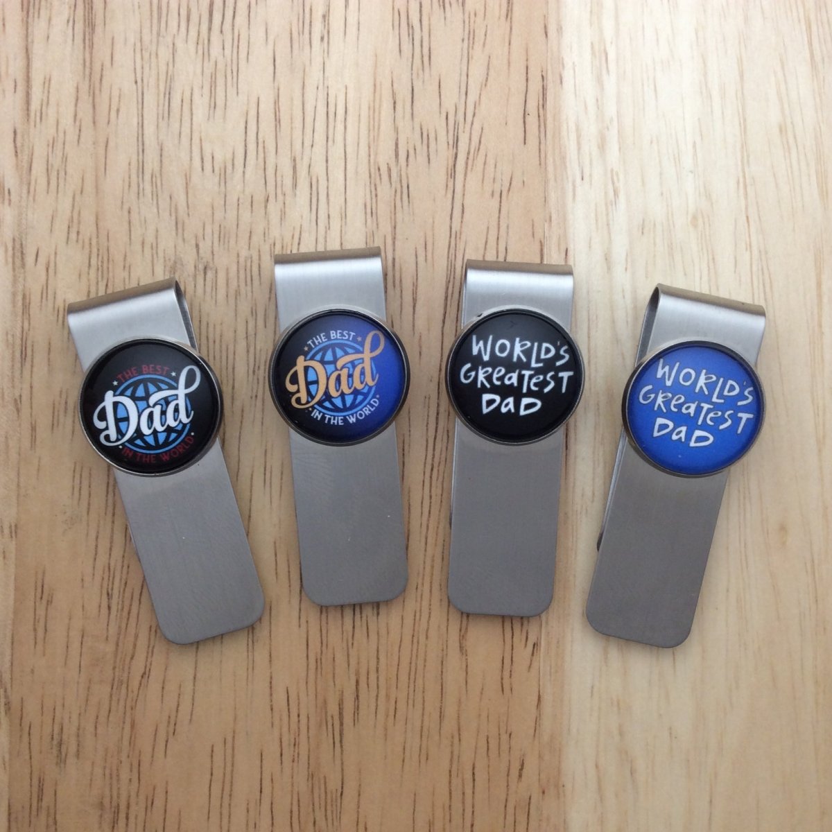 4 stainless steel money clips with glass cabochons that  have fathers day sayings