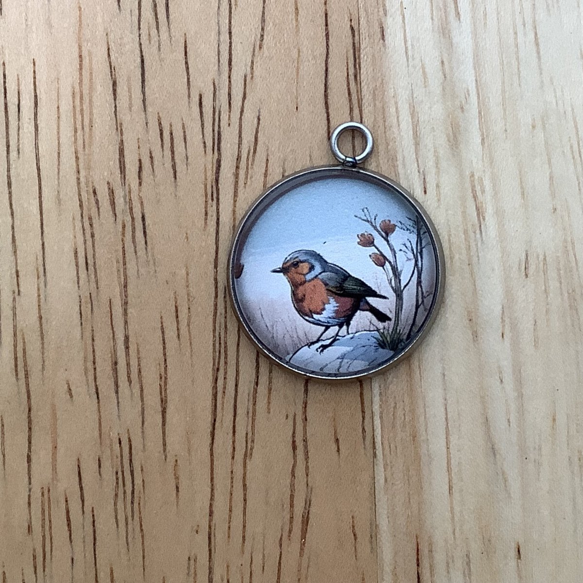 a small brown bird next to a flower in a field