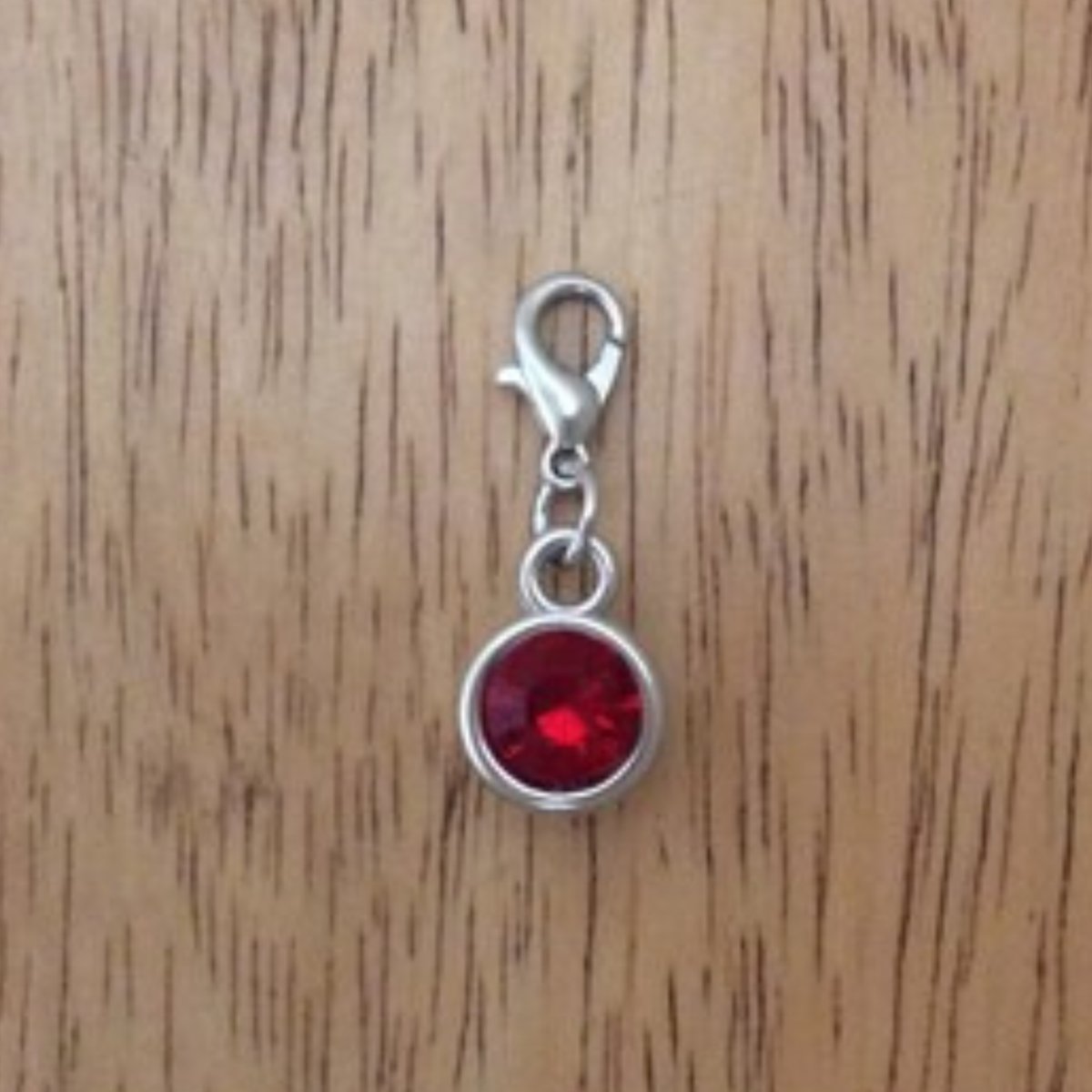 red gemstone charms with a lobster clasp