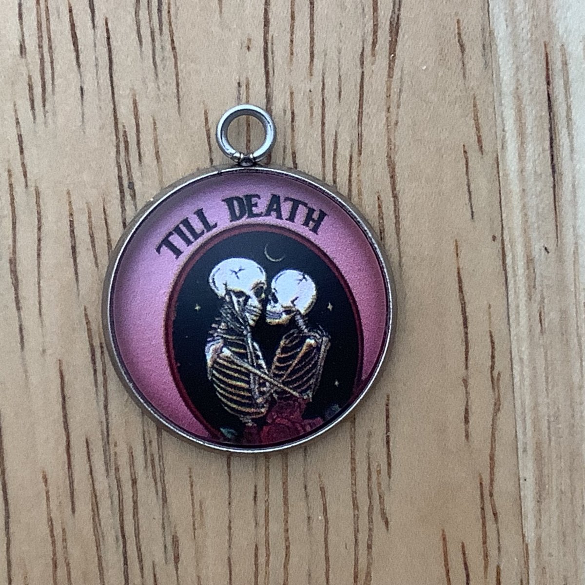 2 skeletons embracing with the words 'till death' 