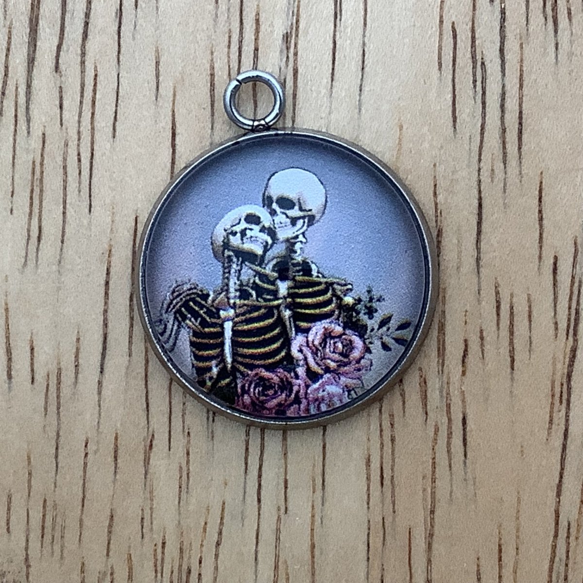 2 skeletons embracing with roses in the foreground