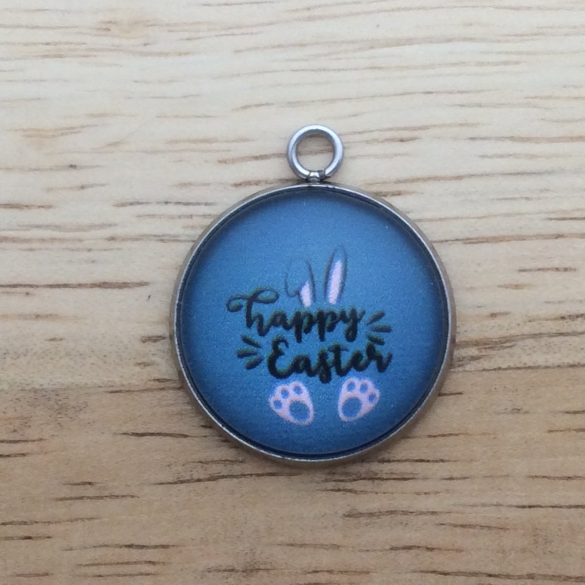 glass cabochon charm that says Happy Easter with bunny ears and feet