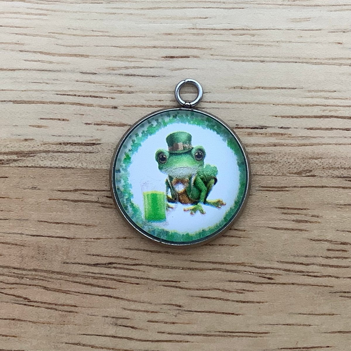 a frog with a top hat and a beer in a ring of shamrocks