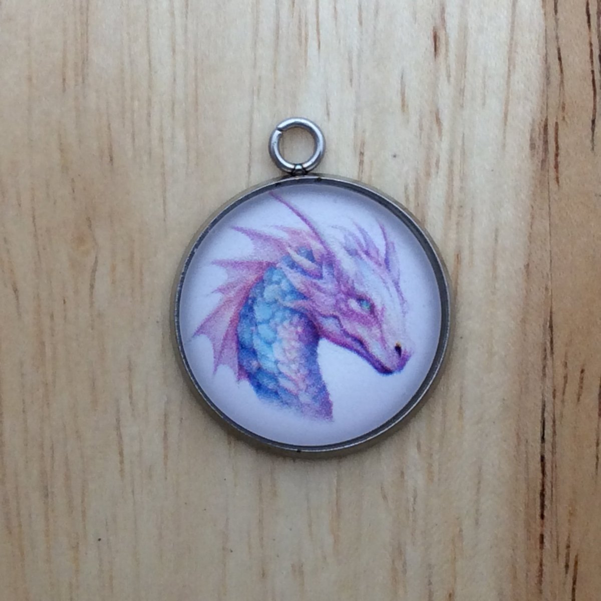 glass cabochon charm with a colorful fairytale dragon