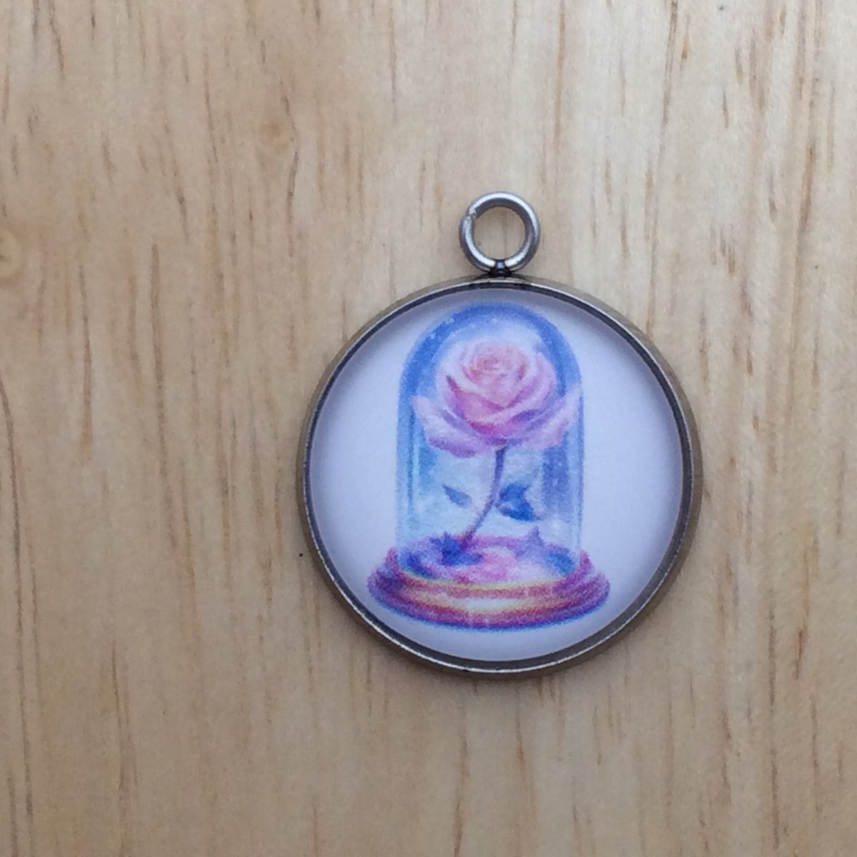 glass cabochon charm with a colorful fairytale rose under glass