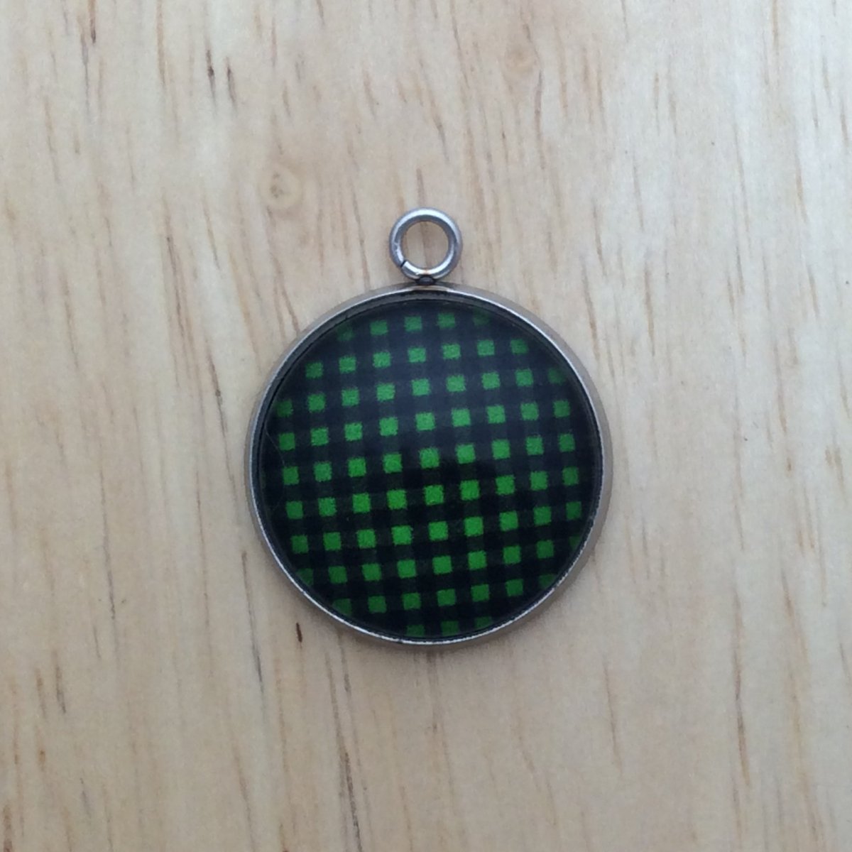 glass cabochon charm with green and black plaid print