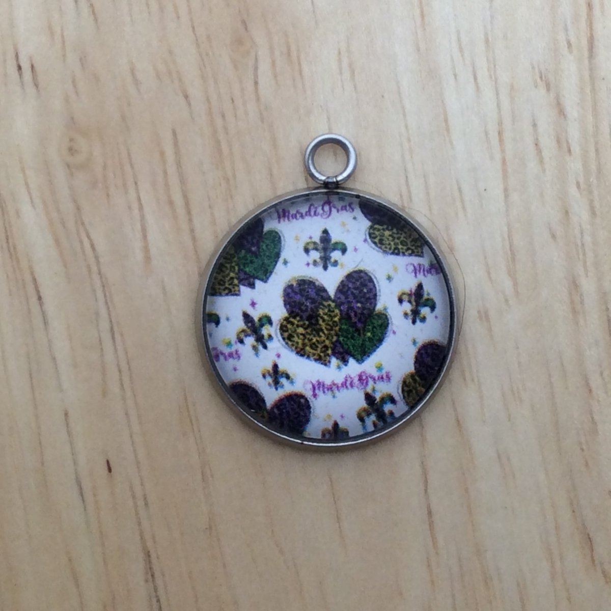 glass cabochon charm with yellow, green and Purple Hearts and Fleur de lis