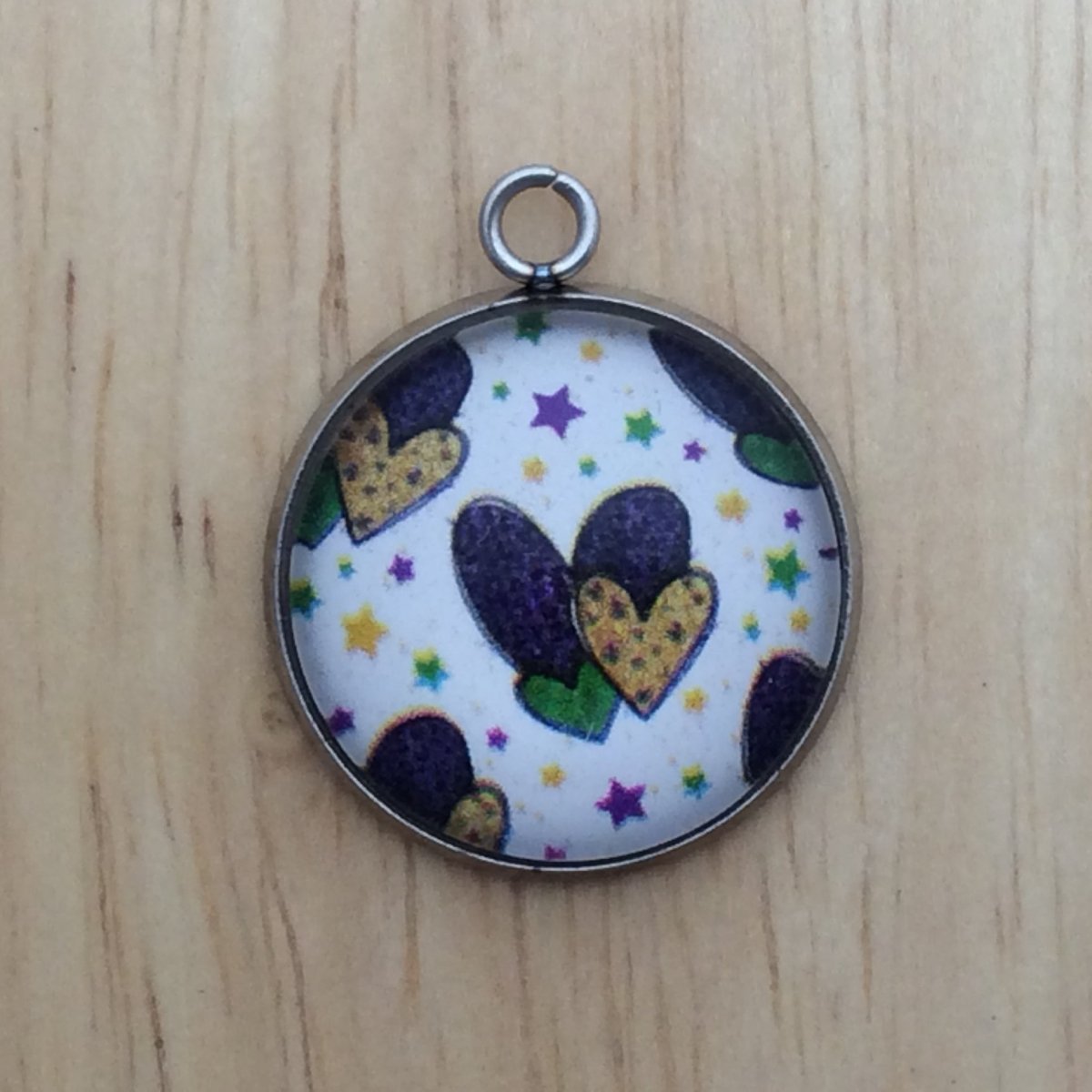 glass cabochon charm with yellow, green and Purple Hearts and stars