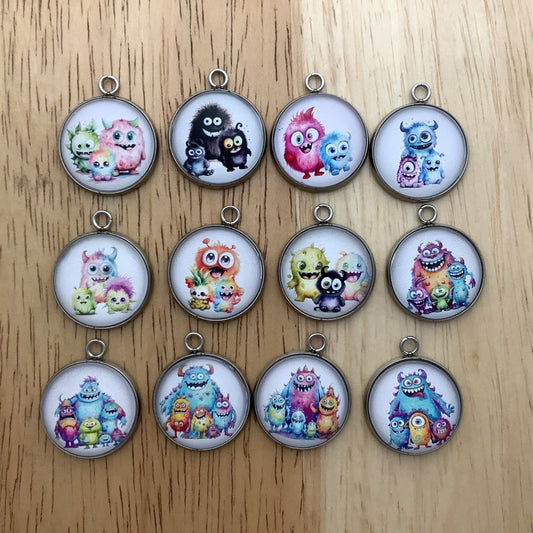 Group of 12 charms featuring cute monsters