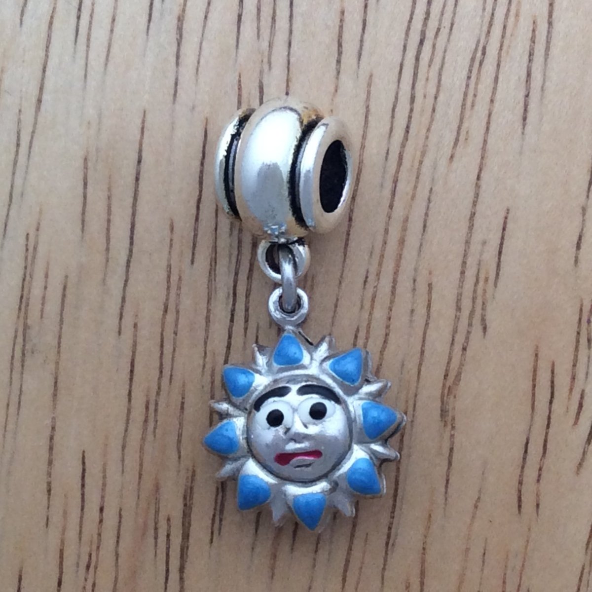 Slider bead with a blue sun charm