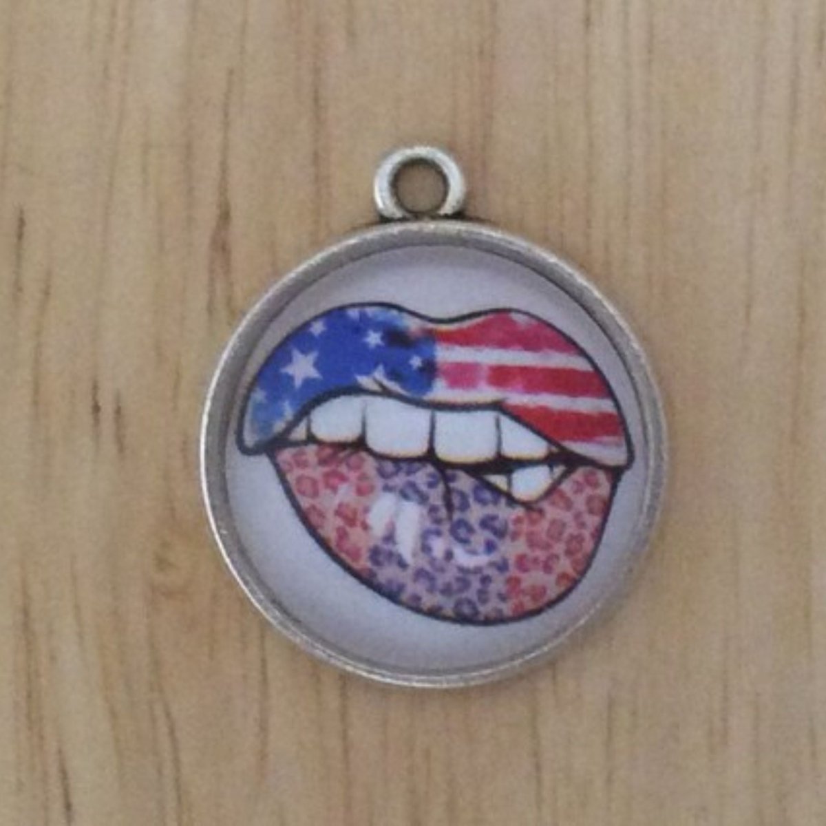 glass cabochon charm with American flag biting lips