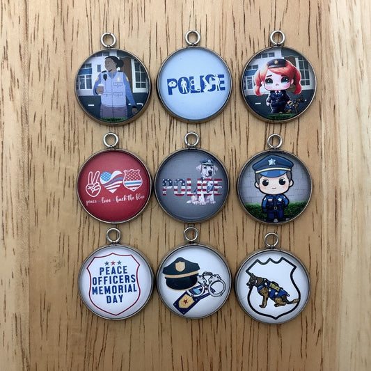 Group of 9 charms featuring police officers, Police dogs, and equipment 