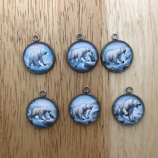 Group of 6 charms depicting polar bears on a glaciar