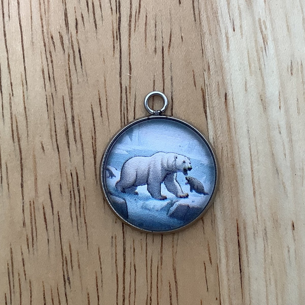 a charm depictin a seal and a polar bear arguing on the rivers edge